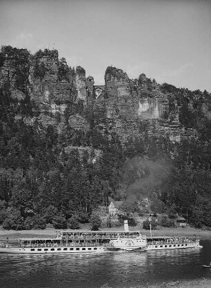 Sächsische Schweiz. Personenseitenraddampfer "Dresden" (1926, Werft Laubegast) auf der Elbe. Blick gegen Basteifelsen und -brücke