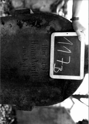 Grabstein 117 (Index: 100111242) Material: Sandstein Zustand: leicht verwittert Maße HxBxT: 146x60x25 cm Beschreibung: Stele, Sockel, Rundbogenaufsatz über ausgezogenem Steleteil, rechteckig erhöht Symbolik: Rosen: Grabstein 117B