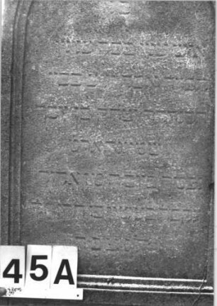 Grabstein 45 (Index: 100114480) Material: Kalkstein Zustand: verwittert mit Textverlust Maße HxBxT: 180x58x29 cm Beschreibung: Stele, Sockel, Rundbogenabschluß mit Mittelakroter auf Voluten, deutsches Schriftfeld rechteckig Symbolik: Palmette und Voluten: Grabstein 45A