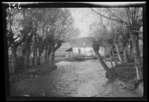 Câmpulung (Rumänien): Bach mit hohem Wasserstand, im Hintergrund eine Brücke und ein breites Gebäude (Mühle?)
