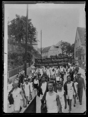 Umzug von Arbeitersportlern in Dohna nach dem 3.Mai 1932, auf Transparenten die Losungen: "Wir fordern die Aufhebung des Verbotes der Proletarischen Freidenker" und "Weltspartakiade"