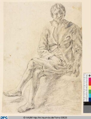 Sitzender junger Mann mit übergeschlagenem linkem Bein