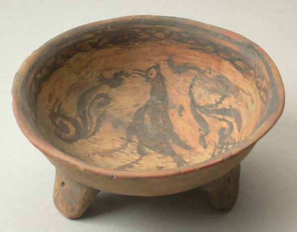 Three-footed clay bowl