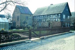 Haus mit Wirtschaftsgebäude, Zaun und Garten