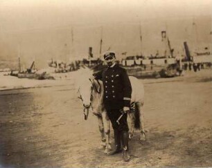 Akureyri/ Island: Herr in Uniform posiert mit Ponyauf dem Hafenplatz von Akureyri
