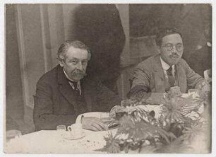 Aristide Briand bei einem Pressefrühstück in Genf. links: Aristide Briand