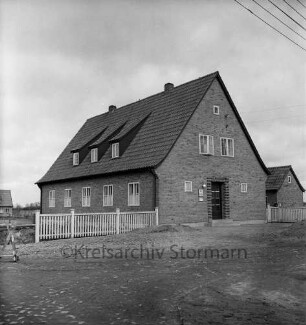 Amt Mollhagen: Amtshaus: links Holzzaun: dahinter Baustelle und hinten Wohnhaus: hinten rechts kleines Haus