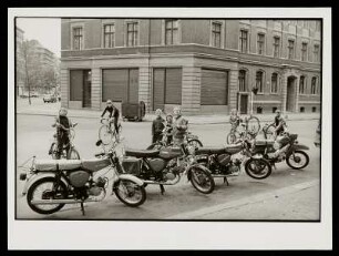 Straßenszene mit Simson Mopeds und Kindern auf ihren Fahrrädern