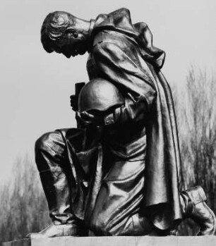 Eine der beiden Bronzeskulpturen eines knieenden Soldaten der Sowjetischen Armee am Hauptweg