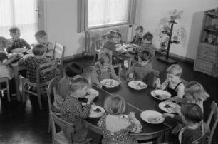 Essende Kinder im Gruppenraum des Kindergartens