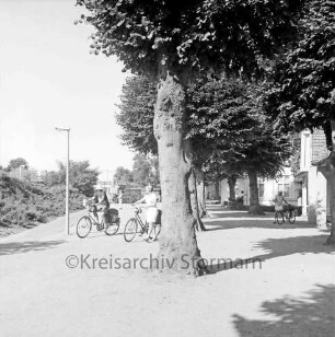 Bürgerpark: Weg zwischen Konrad-Adenauer-Ring (links) und Jugendherberge Bad Oldesloe (rechts): Personen auf dem Weg, Blick Richtung Osten
