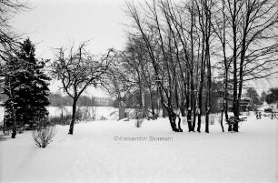 Ahrensböker Straße: Matthias-Claudius-Denkmal, dahinter Herrenteich im Winter