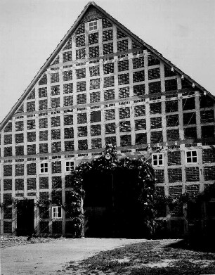 Lindhorst (Grafschaft Schaumburg-Lippe). Hochzeit auf einem Bauernhof. Nach altem Brauch wird der Hauseingang geschmückt