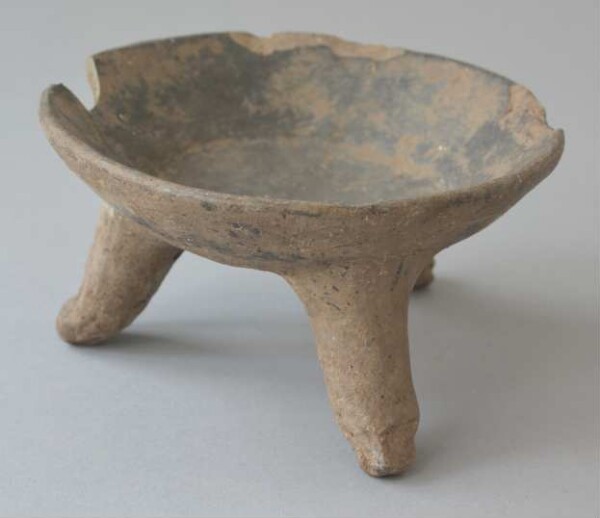 Three-footed clay bowl