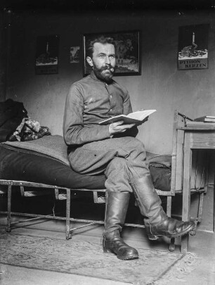 Rudolf Zimmermann : Portrait von Rudolf Zimmermann in Uniform auf einem Bett sitzend.