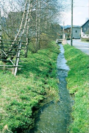 der Gebersbach neben der Straße; Betonwabenplatten am Ufer