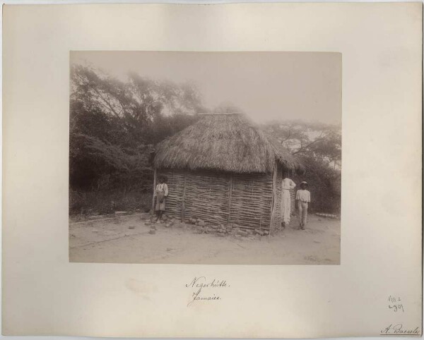 Woman and children in front of a hut in Jamaica