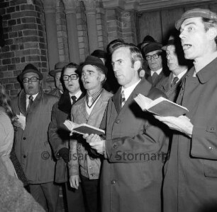 Kirchberg: Weihnachtskonzert vor der Kirche: Städtischer Musikkreis: Oldesloer Männerchor von 1844: hinten Kirchenportal: Abend: 23.12.1974