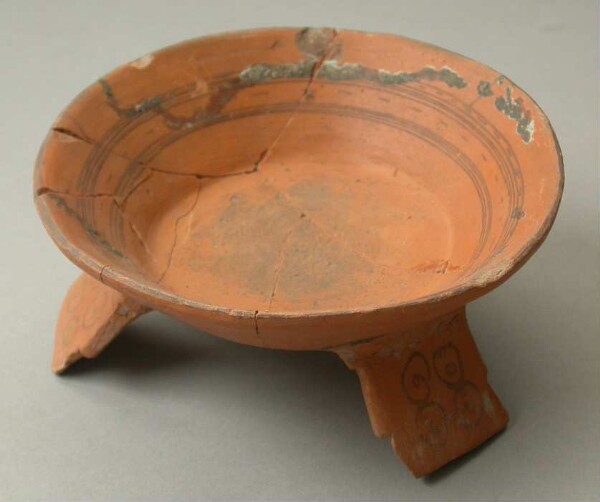 Three-footed clay bowl