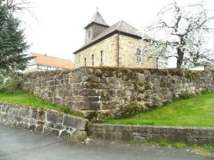 Heina-Evangelische Kirche - Ansicht von Südosten mit Kirche über Kirchhofmauer (einst wehrhafe Kirchhofmauer - jetzige Höhe ein Viertel Original) in übersichtlichem Verlauf