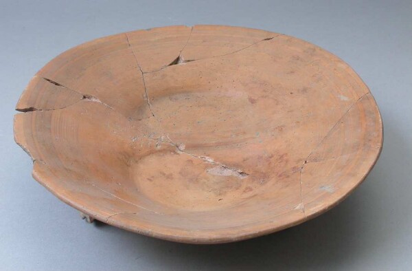 Three-footed clay bowl