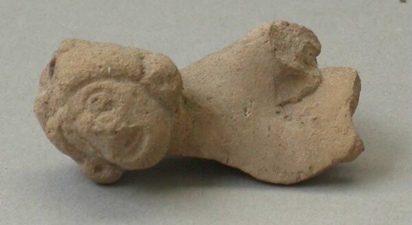 Fragment of a clay rattle (upper body with head of a clay figure)