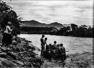 Übersetzen über den Rio Mizque : Personen an einem Flussufer. Eine Gruppe von Männern mit einem Kleinen Boot im Wasser
