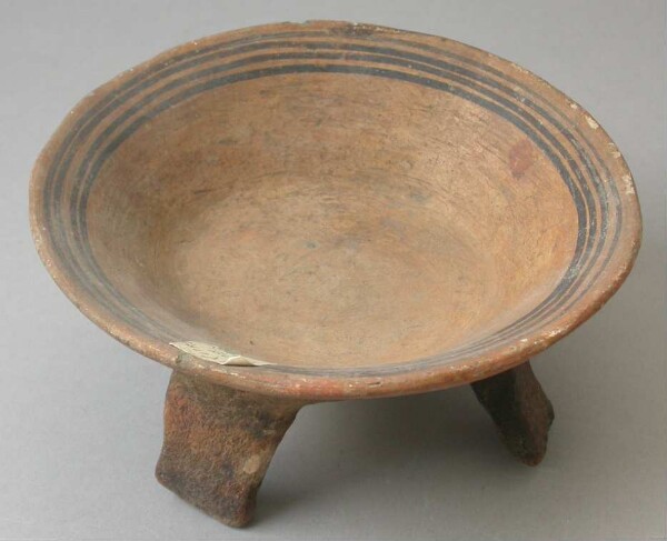 Three-footed clay bowl